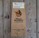 Bone Meal bag sitting on a wooden table.