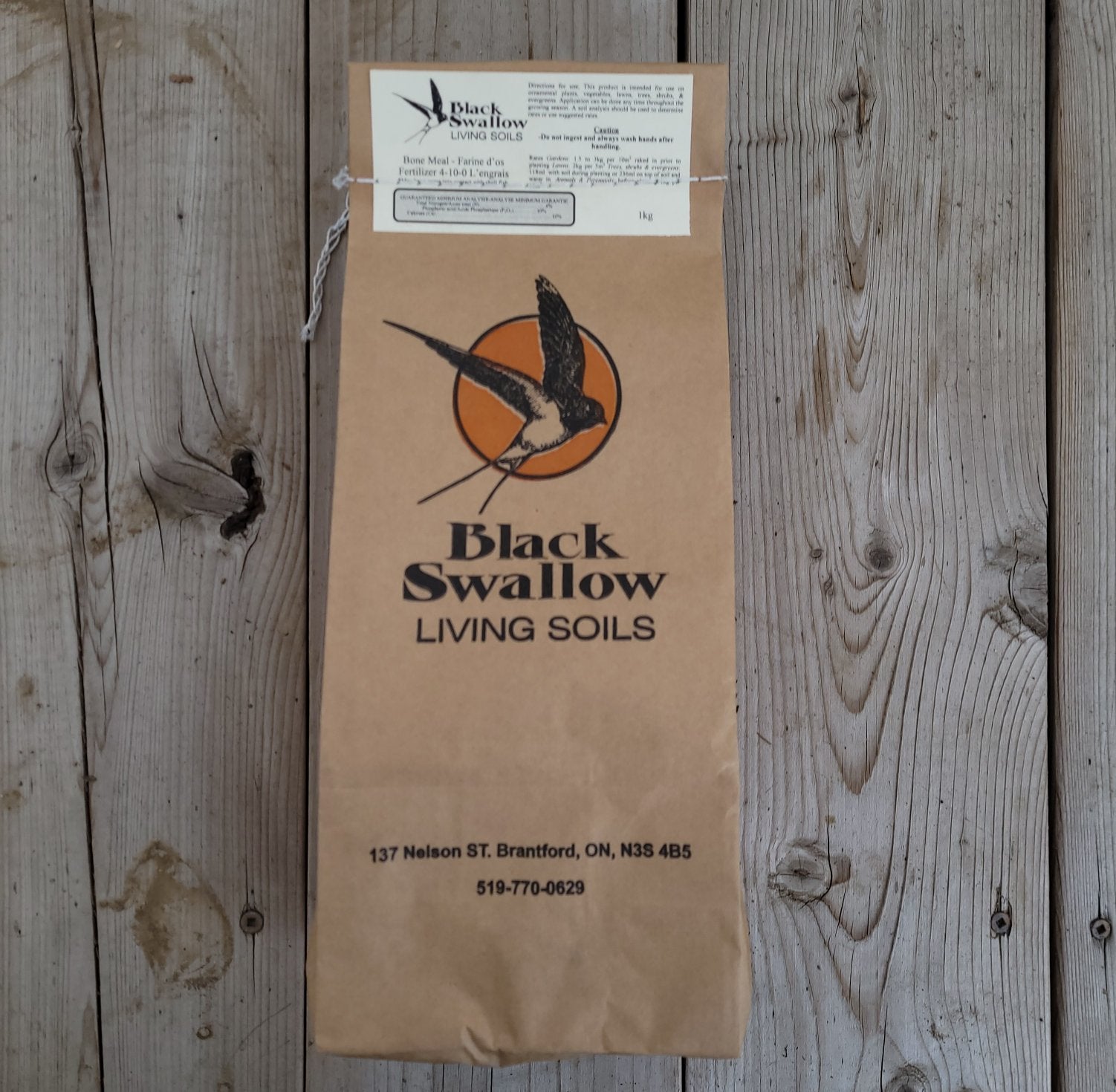 Bone Meal bag sitting on a wooden table.