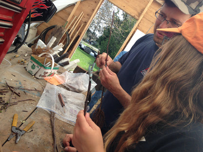 Two workshop attendees learning to graft apple trees. 